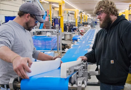 PFI employees building a belt conveyor