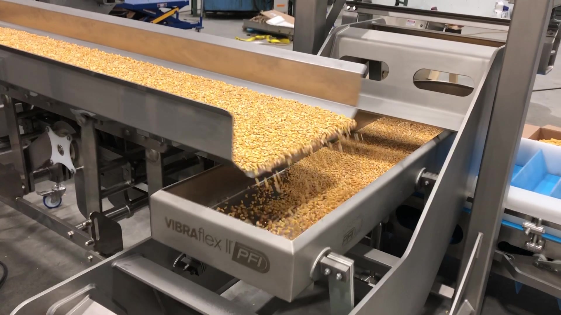 Vibratory conveyor transporting product in a food manufacturing facility